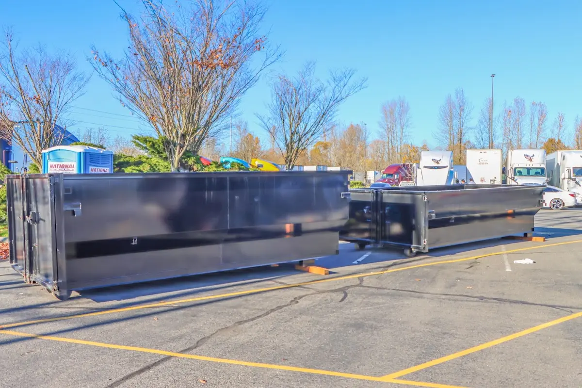 Professional dumpster rental service with roll-off container on residential driveway in Rostraver